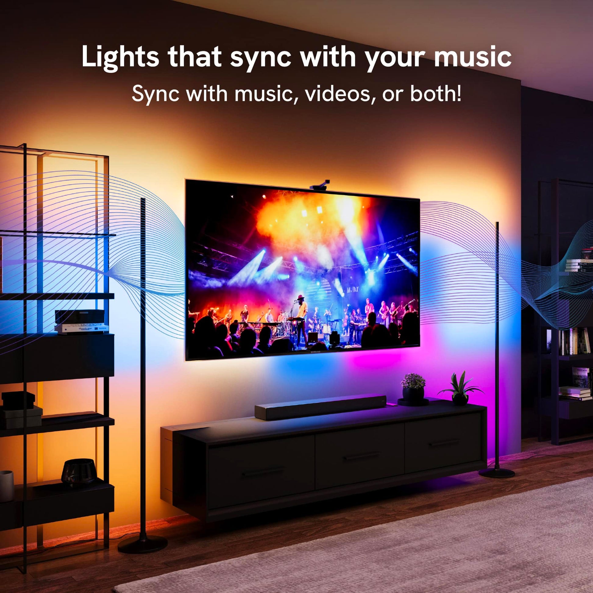 Two floor lamps and tv backlight unit syncing to a music concert on the tv screen.